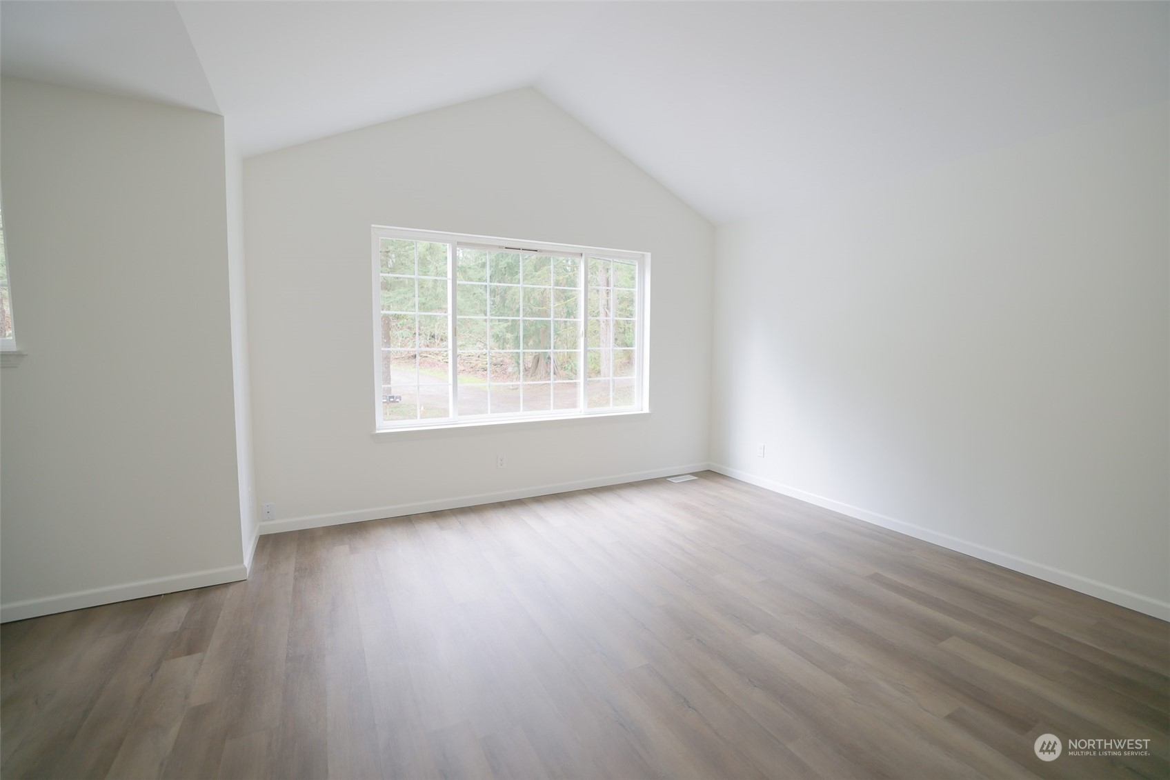 24833 Florence Acres Road Monroe, WA 98272 - Photo 8 of 21 an empty room with wooden floor and windows