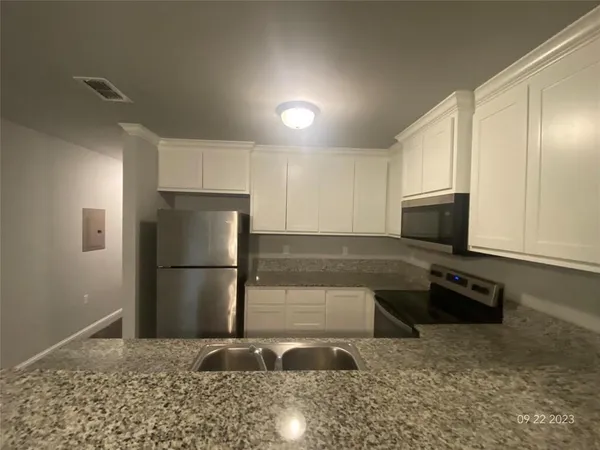 a bathroom with a granite countertop sink a toilet and a vanity