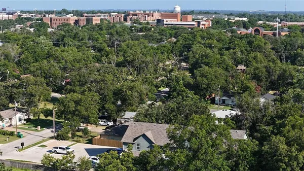an aerial view of a house with a yard