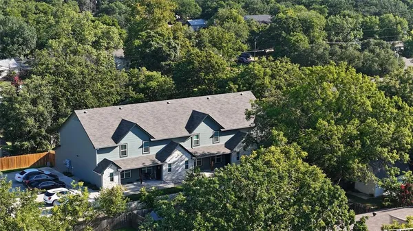 an aerial view of a house with swimming pool and garden space