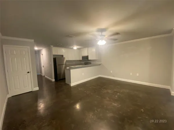 a view of a hallway with wooden floor and closet