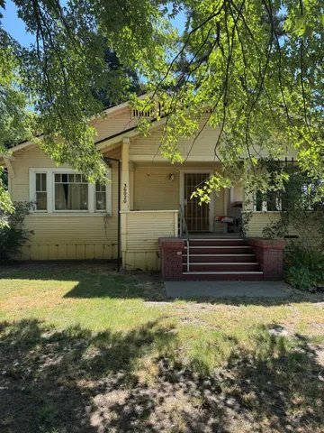a view of a house with backyard and sitting area