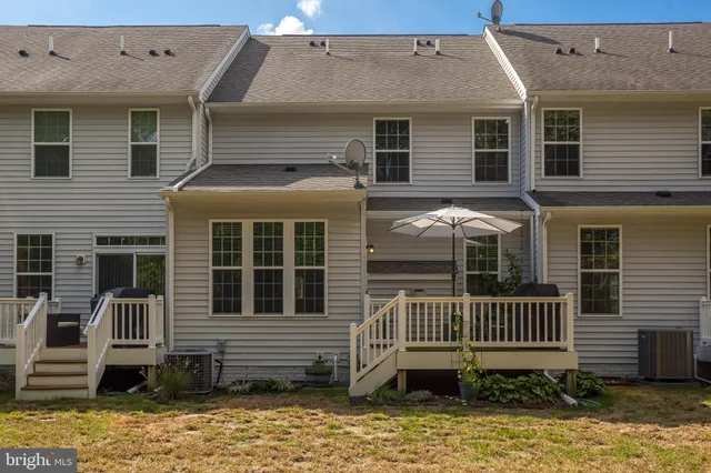 a view of a swimming pool with lawn chairs