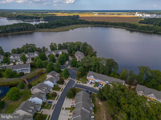 an aerial view of lake and residential houses with outdoor space