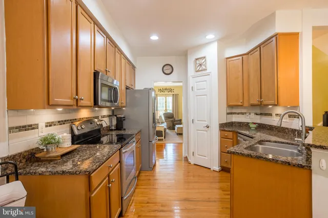 a kitchen with stainless steel appliances granite countertop counter space a sink and cabinets