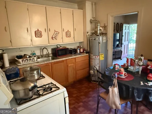 a kitchen with stainless steel appliances a stove a sink and cabinets