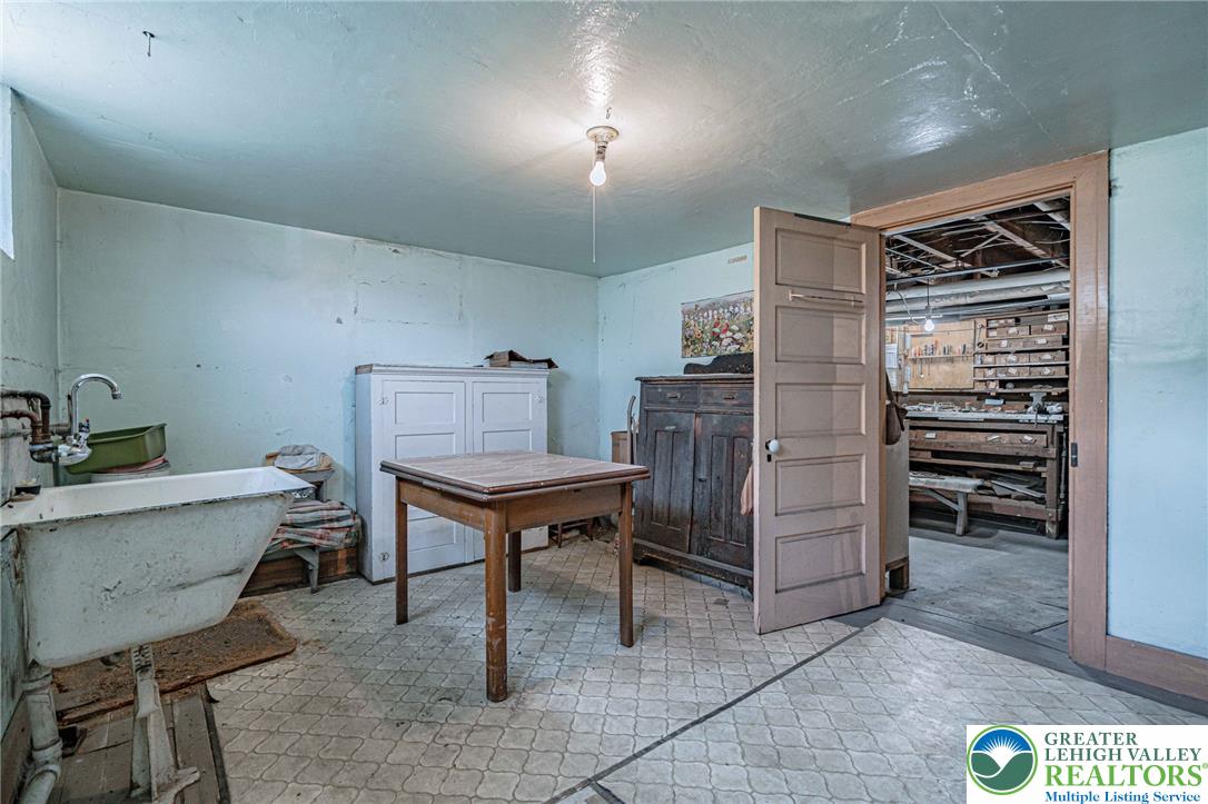 159 West Ridge Street Nesquehoning, PA 18240 - Photo 29 of 55 A utilitarian space, this basement features a laundry sink and provides ample storage potential.