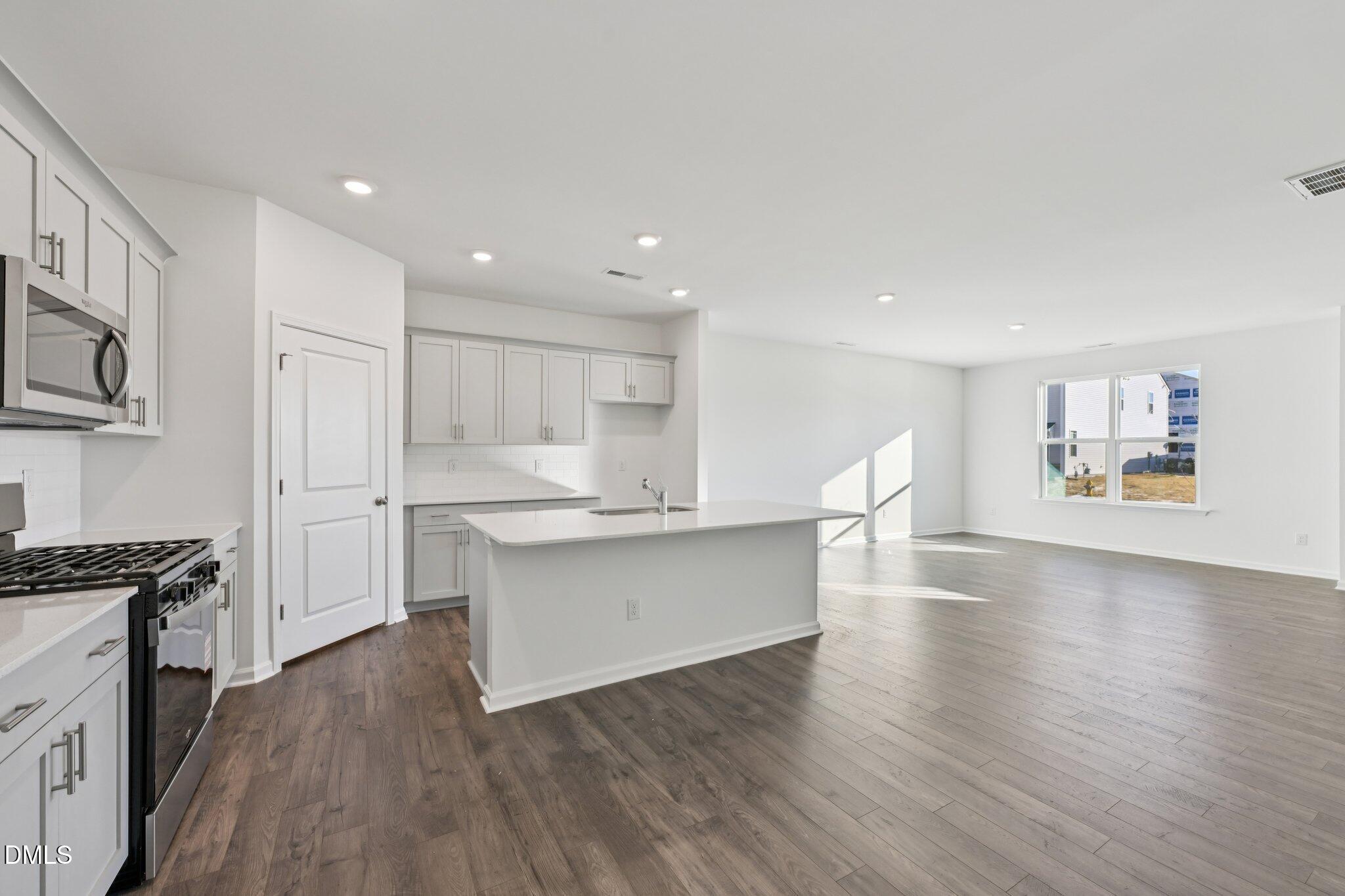 803 Old Tarboro Road Wendell, NC 27591 - Photo 11 of 48 a kitchen with white cabinets and appliances