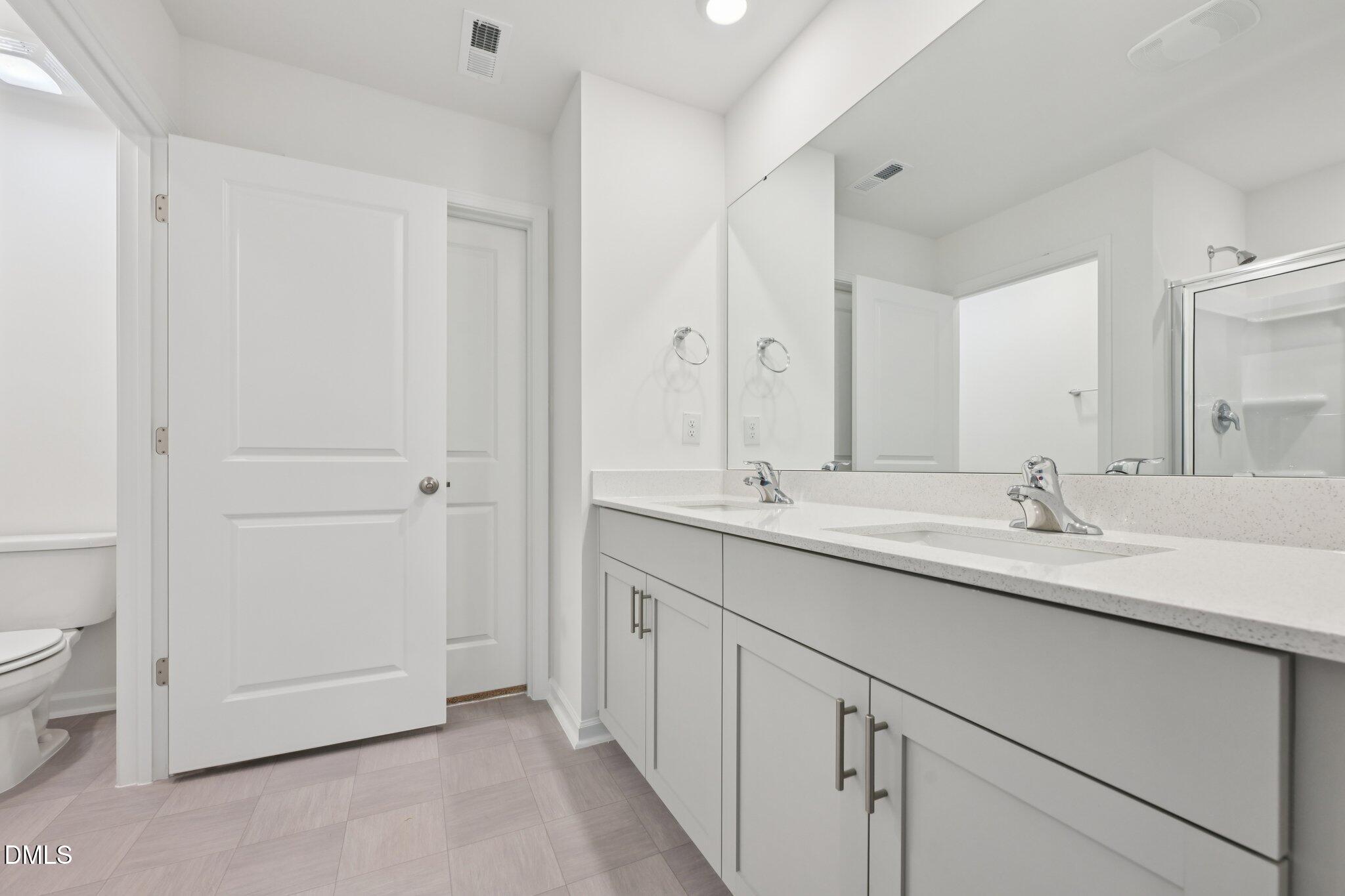 803 Old Tarboro Road Wendell, NC 27591 - Photo 27 of 48 a bathroom with a double vanity sink and toilet
