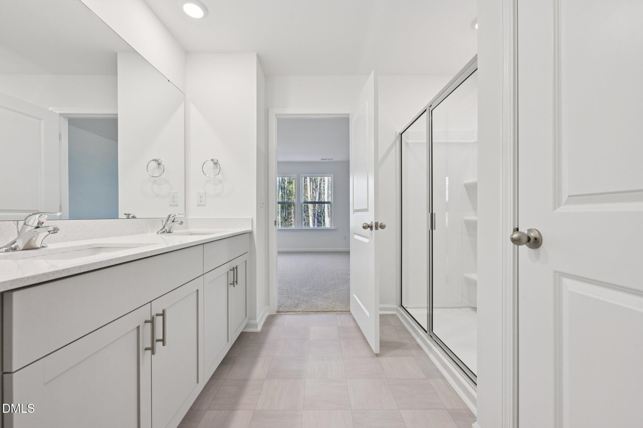 803 Old Tarboro Road Wendell, NC 27591 - Photo 28 of 48 a bathroom with a double vanity sink and mirror