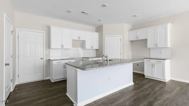 a kitchen with a sink cabinets stainless steel appliances and a window