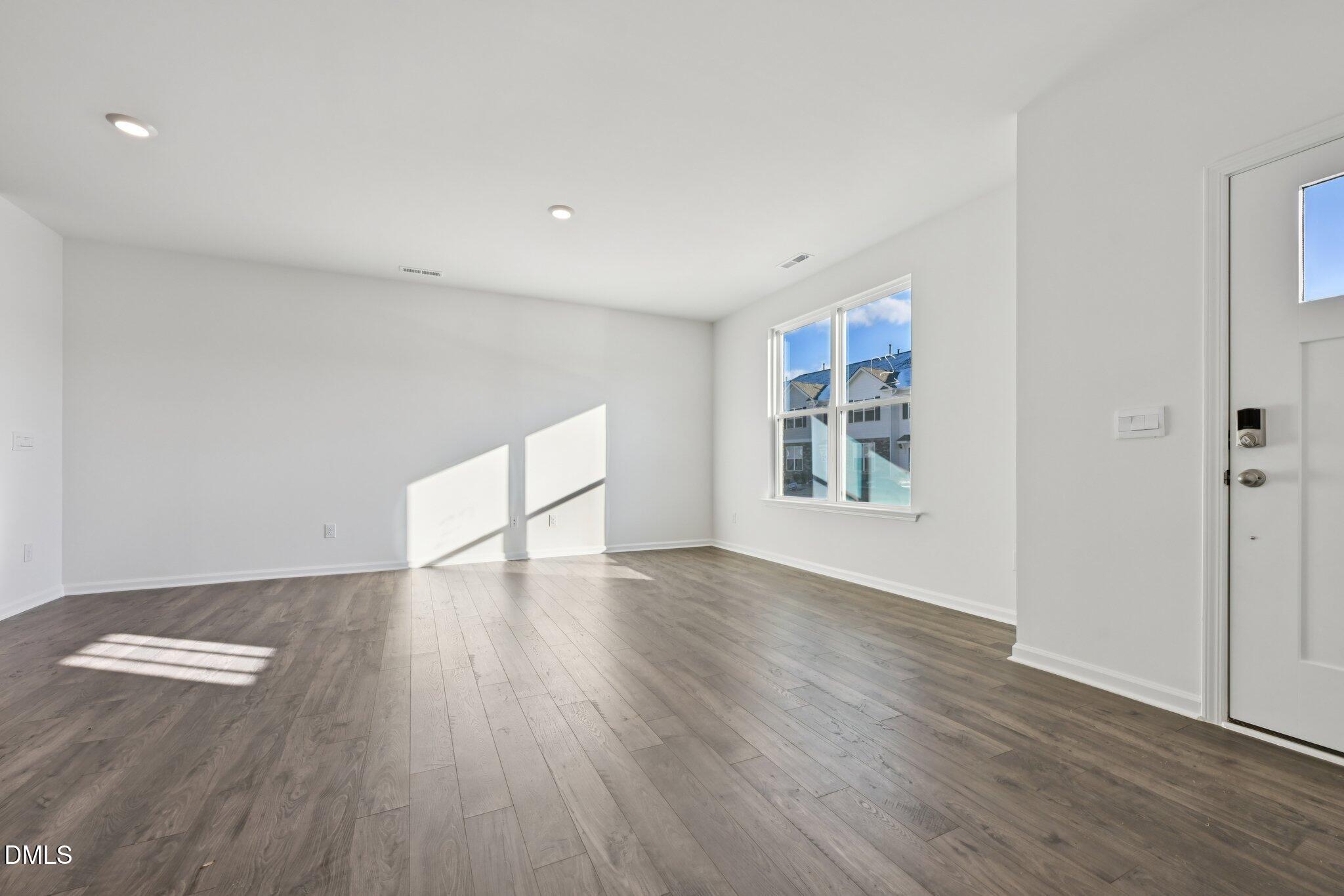 803 Old Tarboro Road Wendell, NC 27591 - Photo 7 of 48 an empty room with wooden floor and windows