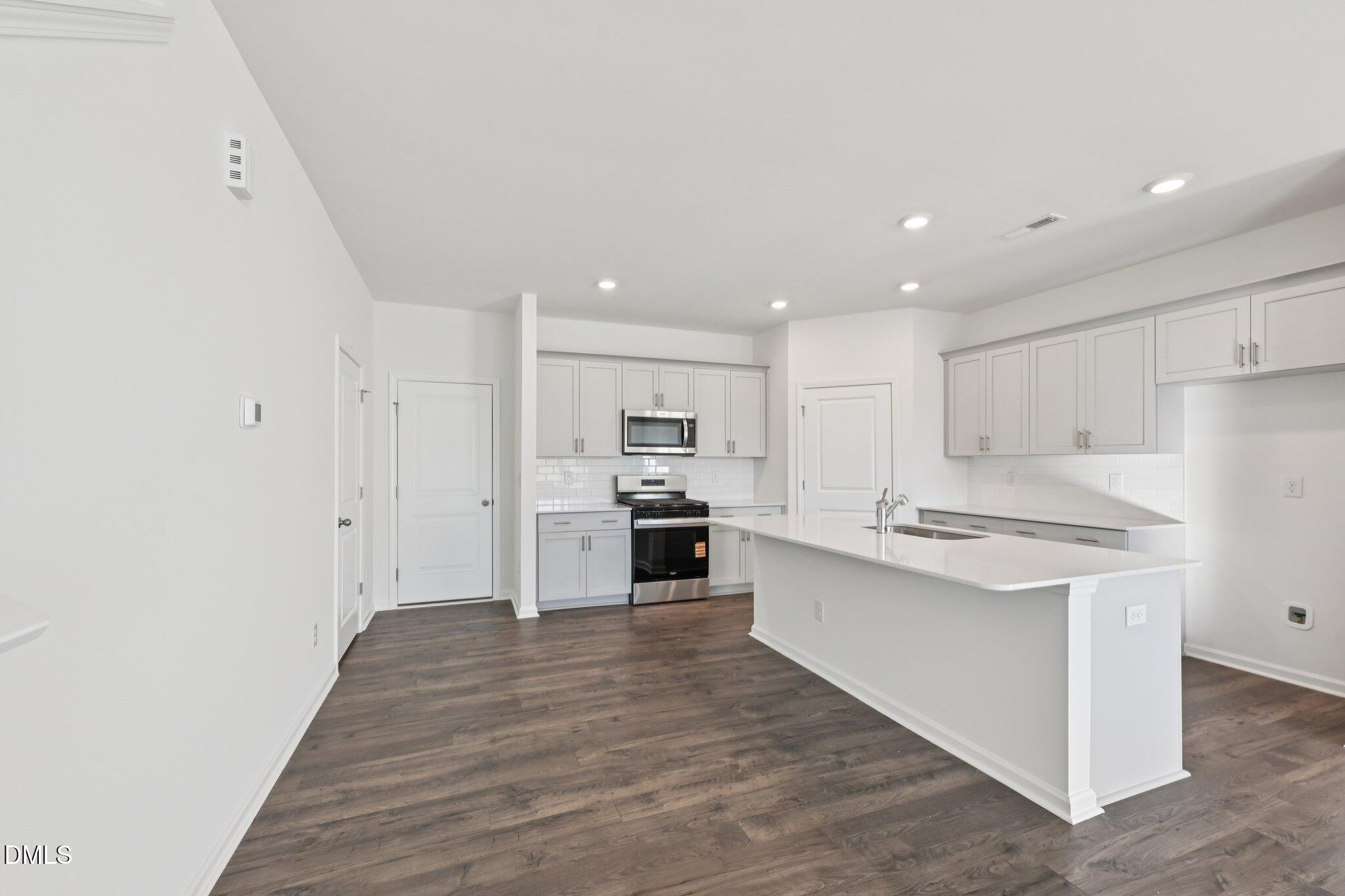 803 Old Tarboro Road Wendell, NC 27591 - Photo 10 of 48 a large kitchen with stainless steel appliances granite countertop a stove and a refrigerator
