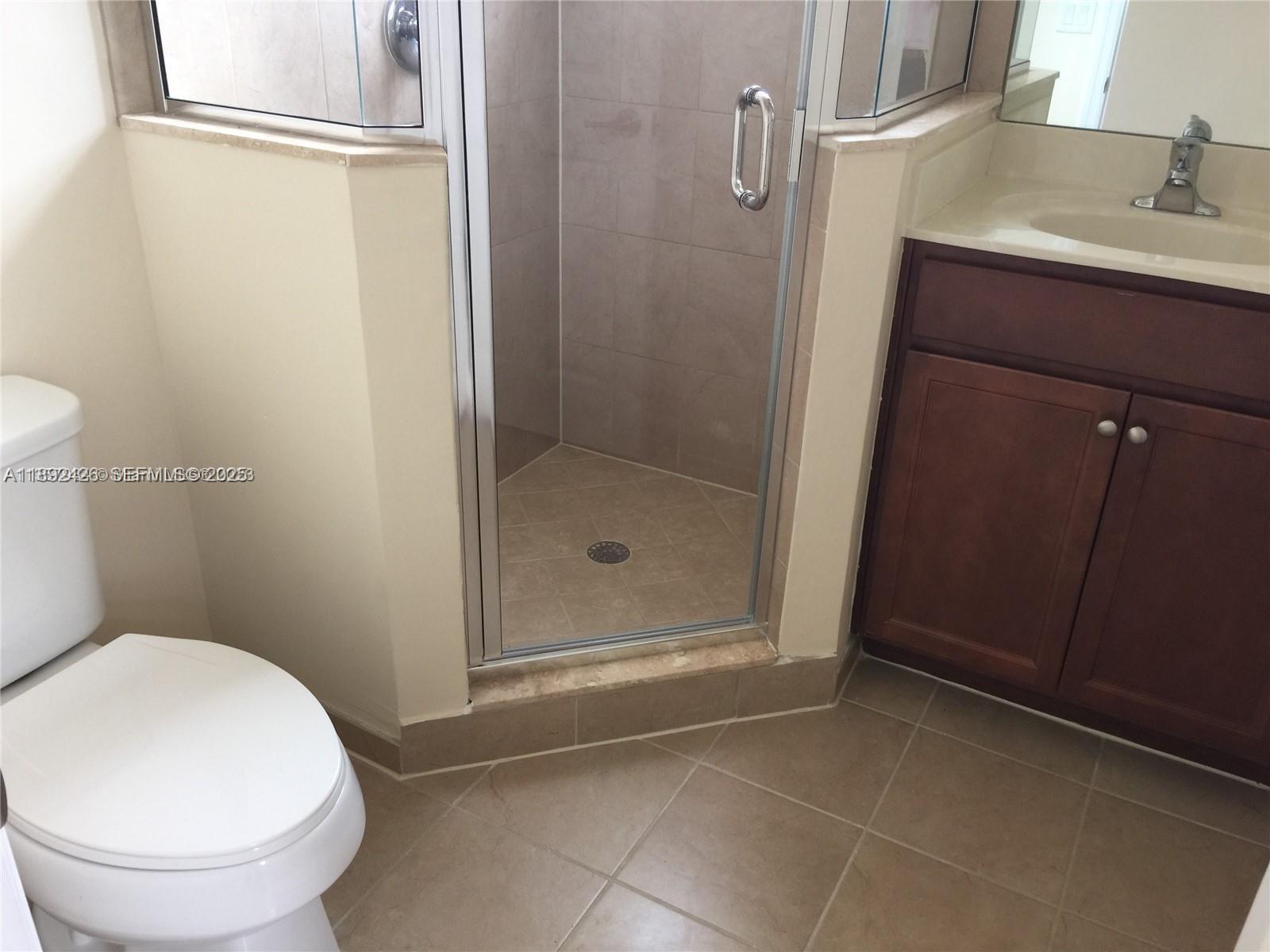 17105 Southwest 96th Street, Unit STUDIO Miami, FL 33196 - Photo 12 of 30 a bathroom with a sink and a toilet