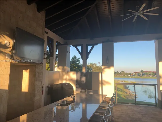 a view of a dining room with furniture large windows and wooden floor