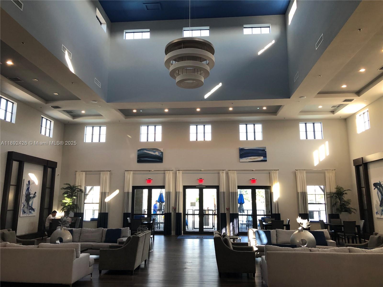 17105 Southwest 96th Street, Unit STUDIO Miami, FL 33196 - Photo 28 of 30 a living room with lots of furniture and chandelier