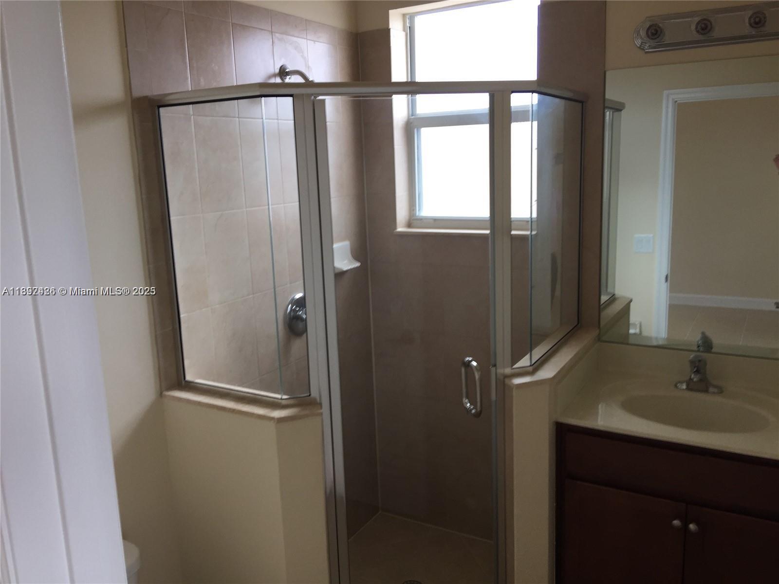 17105 Southwest 96th Street, Unit STUDIO Miami, FL 33196 - Photo 5 of 30 a bathroom with a shower and a sink