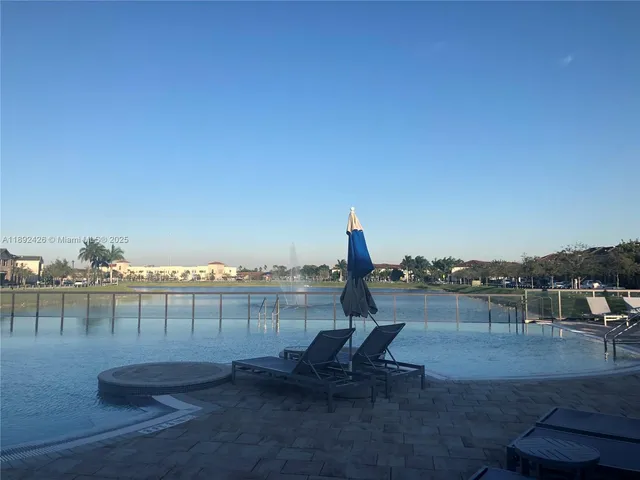 a view of a swimming pool with a table and chairs