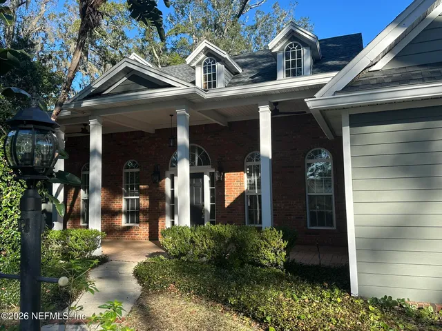 a view of a house with backyard and sitting area