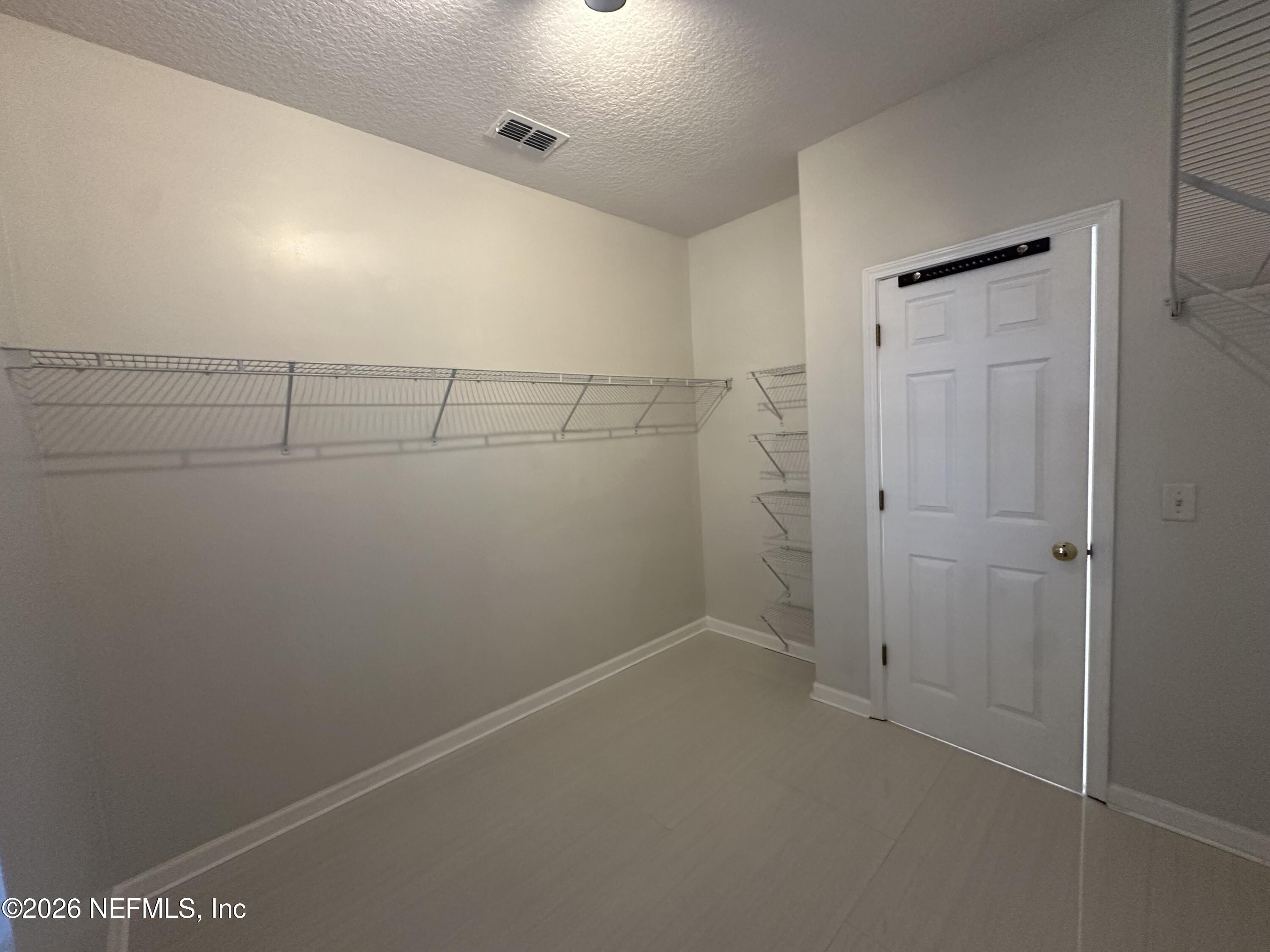 1024 Neptune Lane Neptune Beach, FL 32266 - Photo 35 of 60 a view of a room with racks on the wall