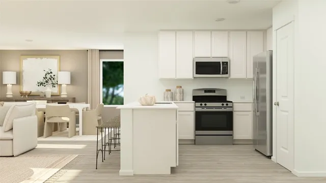 a kitchen with stainless steel appliances a stove a sink and a microwave
