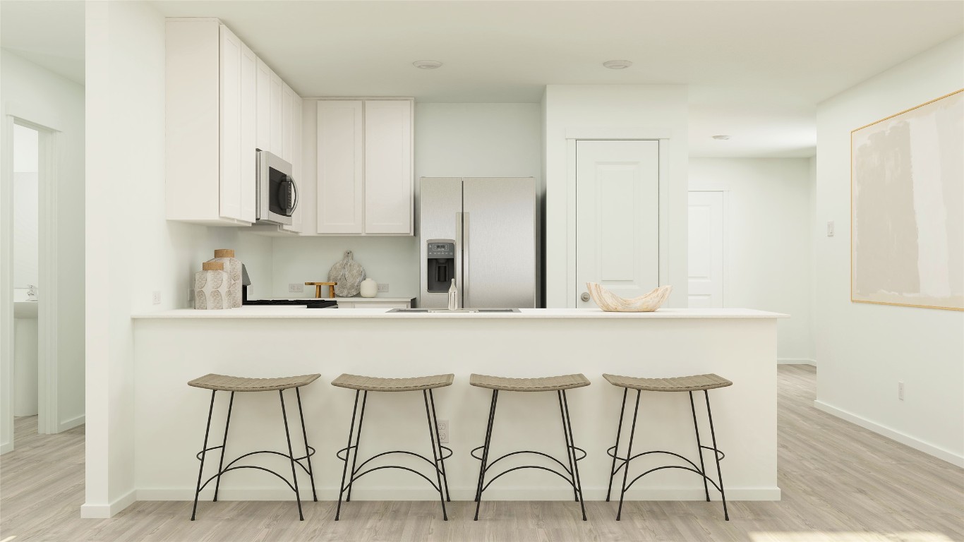 270 Kings Row Lane Jarrell, TX 76537 - Photo 19 of 30 a white kitchen with cabinets a sink and chairs