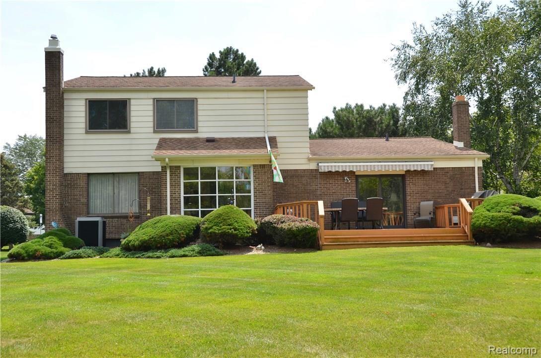 618 Baker Street Rochester, MI 48307 - Photo 24 of 25 Back of home shows deck,retractable awning - looks straight onto 10th tee of Hampton Golf & Recreation