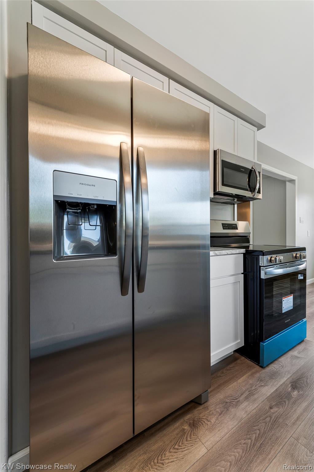 8936 Merriman Road Livonia, MI 48150 - Photo 25 of 49 Stainless steel side-by-side refrigerator with an ice and water dispenser, complemented by matching stainless steel appliances