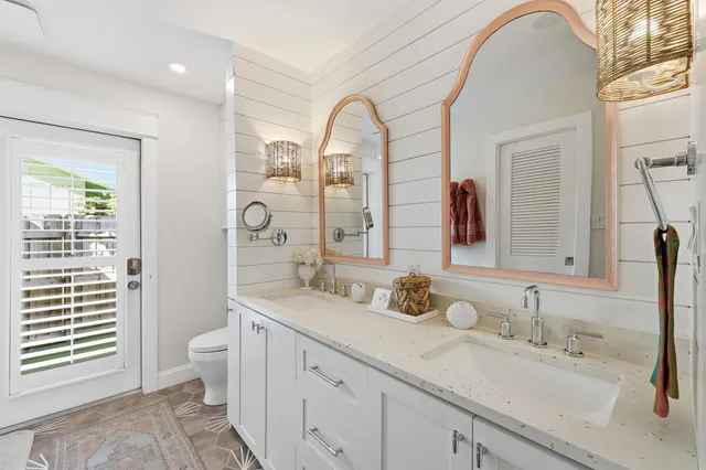a spacious bathroom with a double vanity sink and a mirror