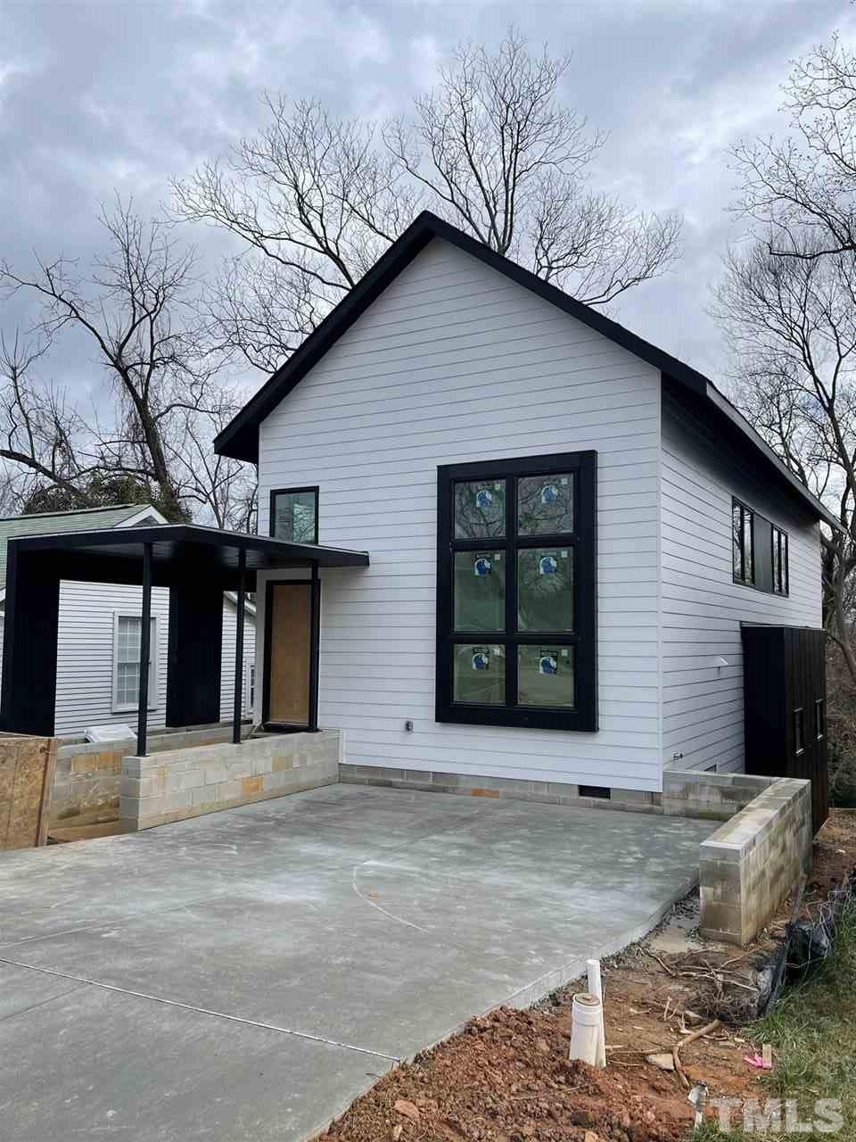 101 Bart Street Raleigh, NC 27610 - Photo 3 of 3 a front view of a house with glass windows and garage