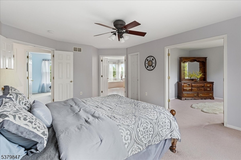 720 Colonial Court Somerville, NJ 08876 - Photo 14 of 33 a spacious bedroom with a bed and ceiling fan