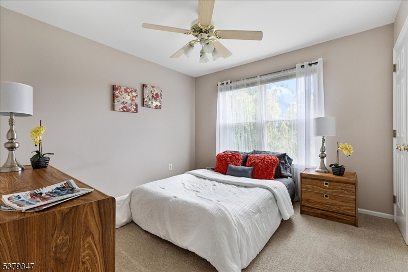 720 Colonial Court Somerville, NJ 08876 - Photo 18 of 33 a bedroom with a bed and a chandelier