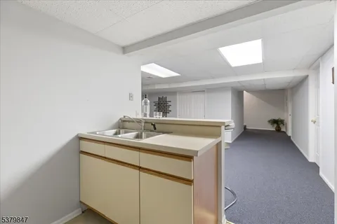 a kitchen with a sink and a mirror