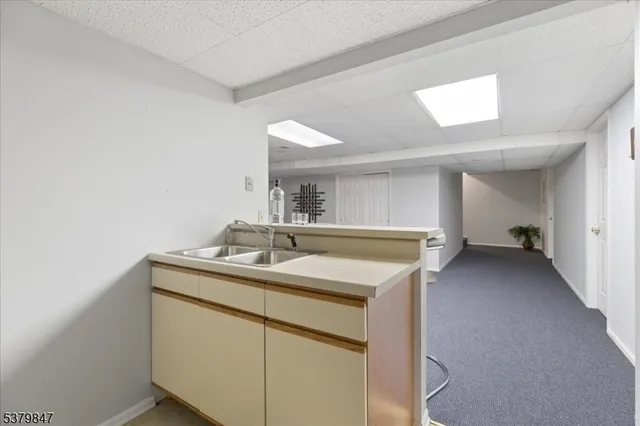 a kitchen with a sink and a mirror