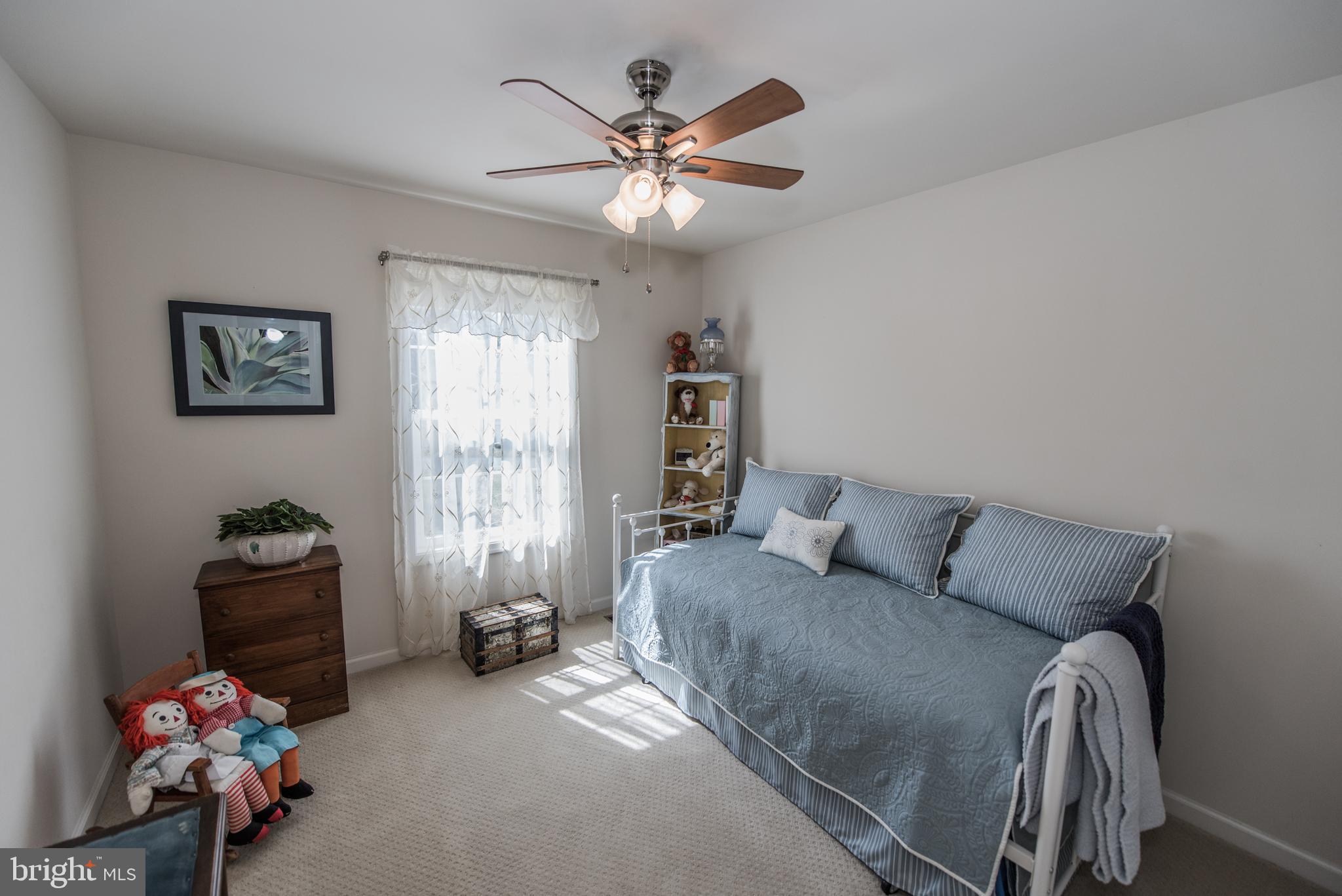 108 Eagle Drive Cross Junction, VA 22625 - Photo 13 of 39 a bedroom with a bed and a chandelier