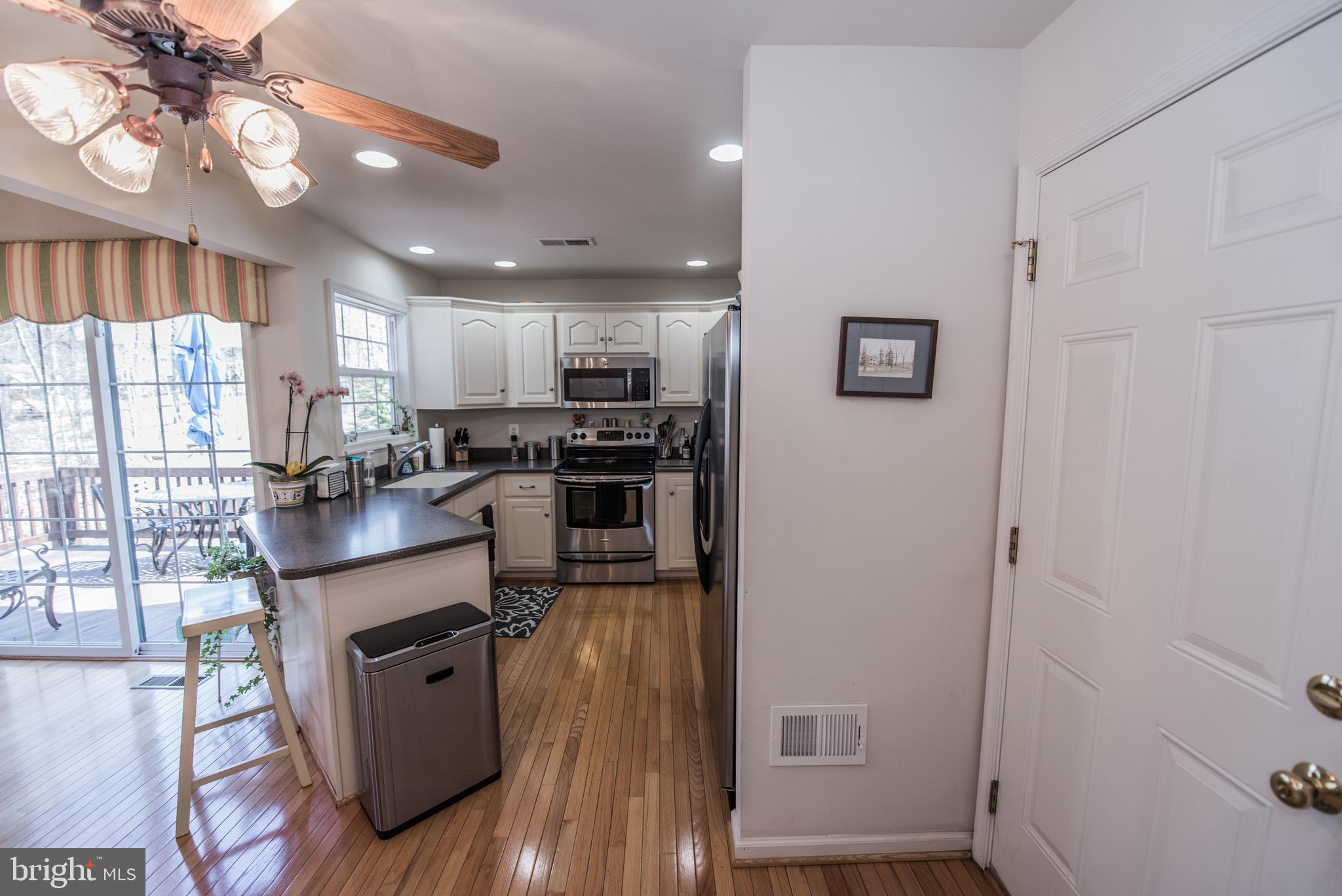 108 Eagle Drive Cross Junction, VA 22625 - Photo 32 of 39 a kitchen with stainless steel appliances granite countertop a refrigerator a stove top oven a sink and dishwasher