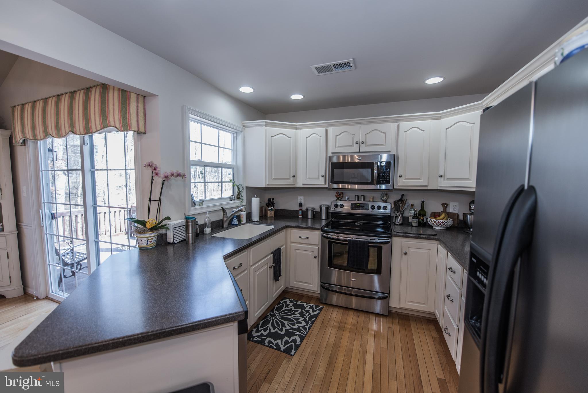 108 Eagle Drive Cross Junction, VA 22625 - Photo 35 of 39 a kitchen with stainless steel appliances granite countertop a refrigerator stove microwave and sink