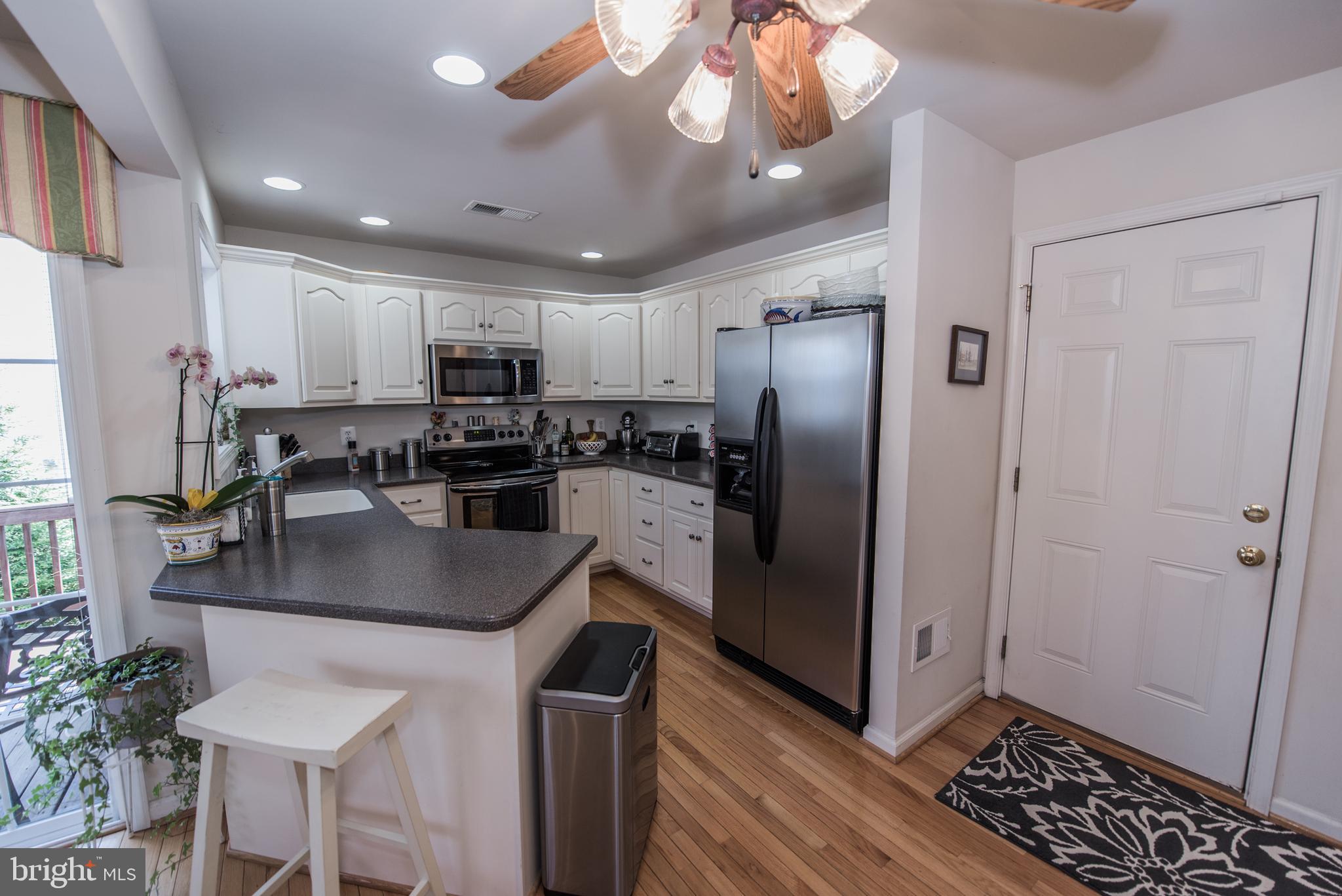 108 Eagle Drive Cross Junction, VA 22625 - Photo 7 of 39 a kitchen with stainless steel appliances granite countertop a refrigerator a stove a sink and a microwave