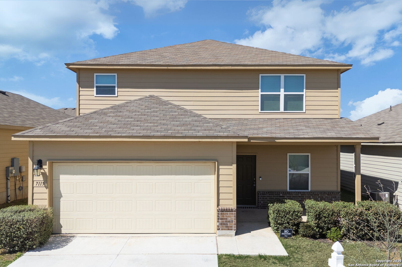 a front view of a house with garage