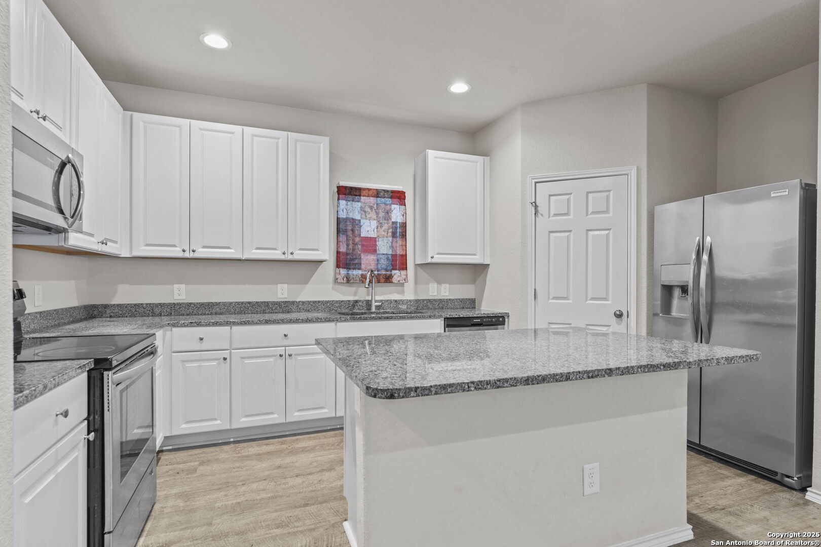 7115 Mesa Cliffs Converse, TX 78109 - Photo 11 of 30 a kitchen with stainless steel appliances granite countertop a sink stove and refrigerator