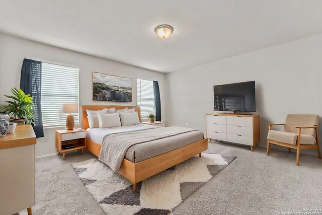 a bedroom with bed and a flat screen tv