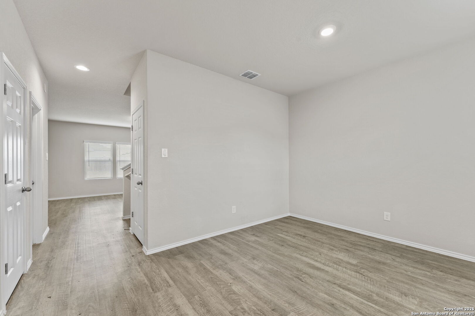 7115 Mesa Cliffs Converse, TX 78109 - Photo 5 of 30 wooden floor in an empty room with a window