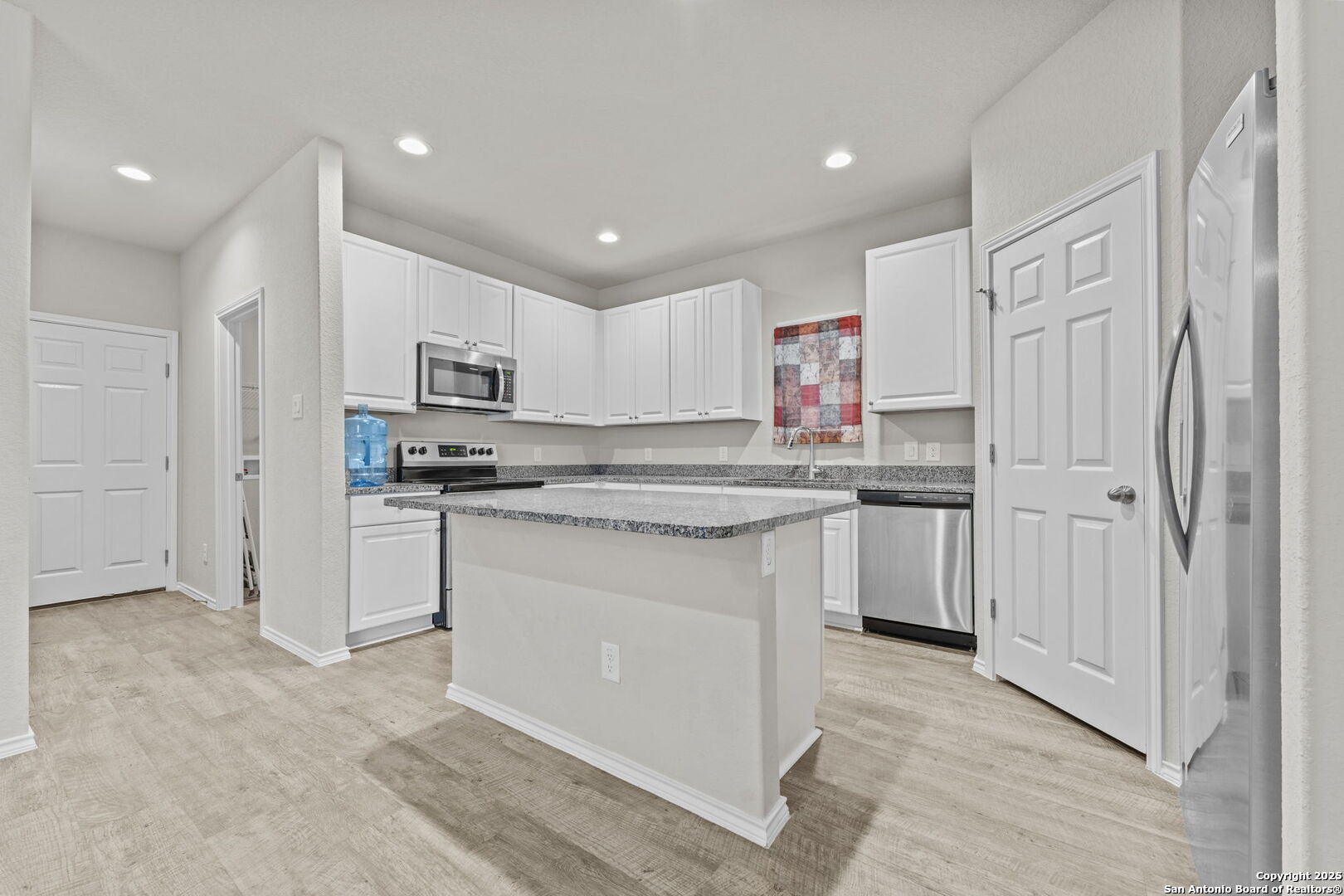 7115 Mesa Cliffs Converse, TX 78109 - Photo 10 of 30 a kitchen with kitchen island granite countertop appliances cabinets and a sink