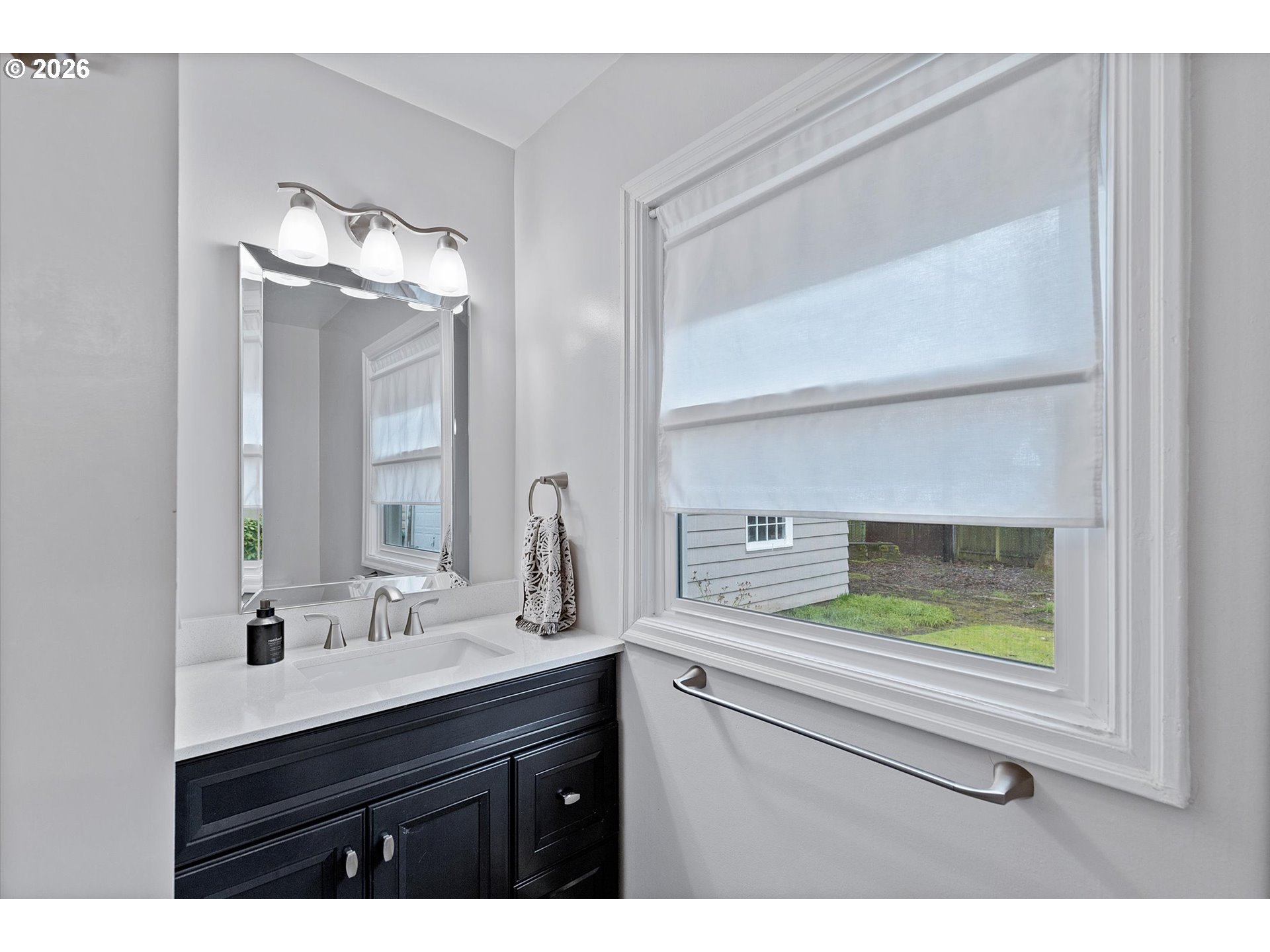 4773 North Yale Street Portland, OR 97203 - Photo 16 of 45 a bathroom with a sink and a mirror