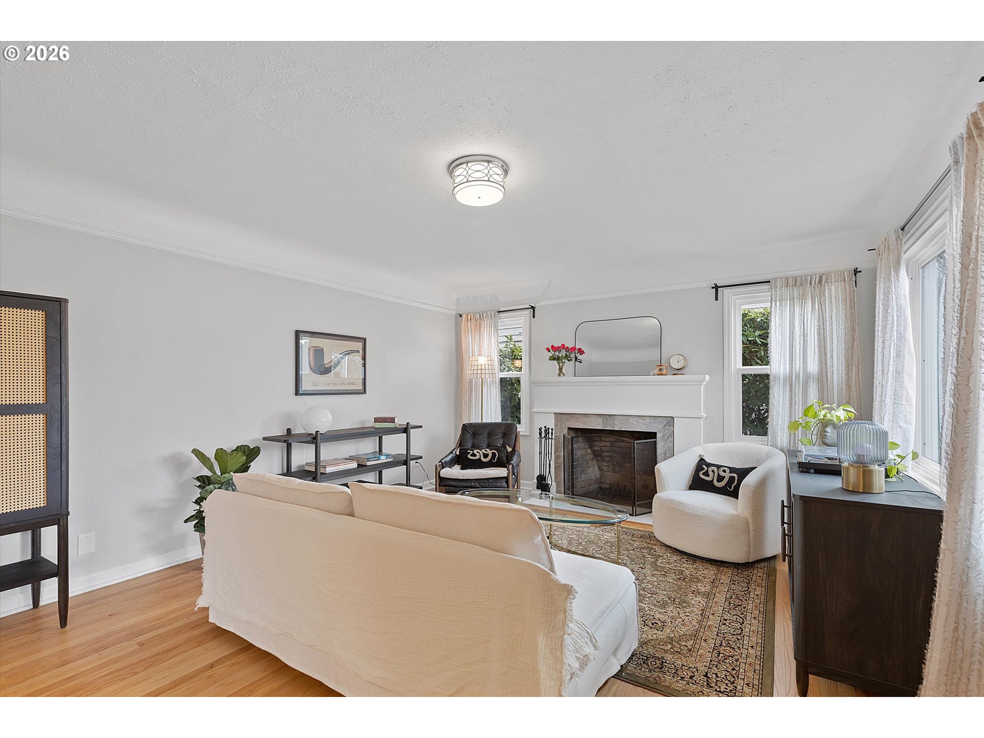 4773 North Yale Street Portland, OR 97203 - Photo 2 of 45 a living room with furniture a fireplace and a potted plant