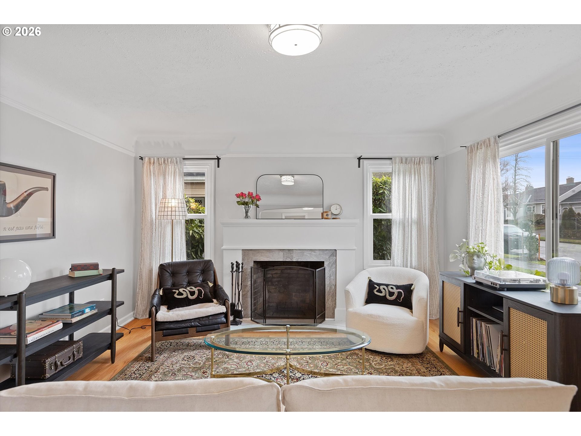 4773 North Yale Street Portland, OR 97203 - Photo 4 of 45 a living room with furniture a fireplace and a floor to ceiling window