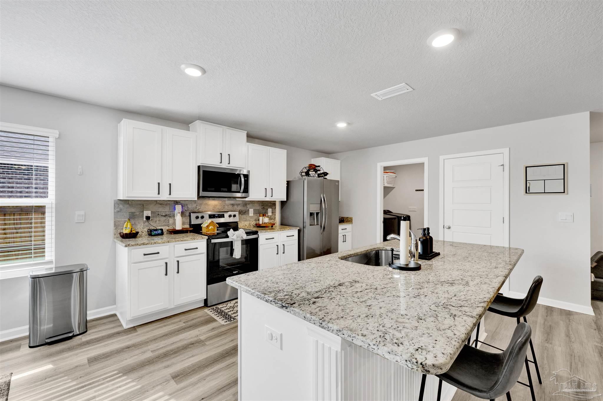 9747 MilleeLoop Loop Pensacola, FL 32526 - Photo 11 of 31 a kitchen with granite countertop a sink counter space and stainless steel appliances