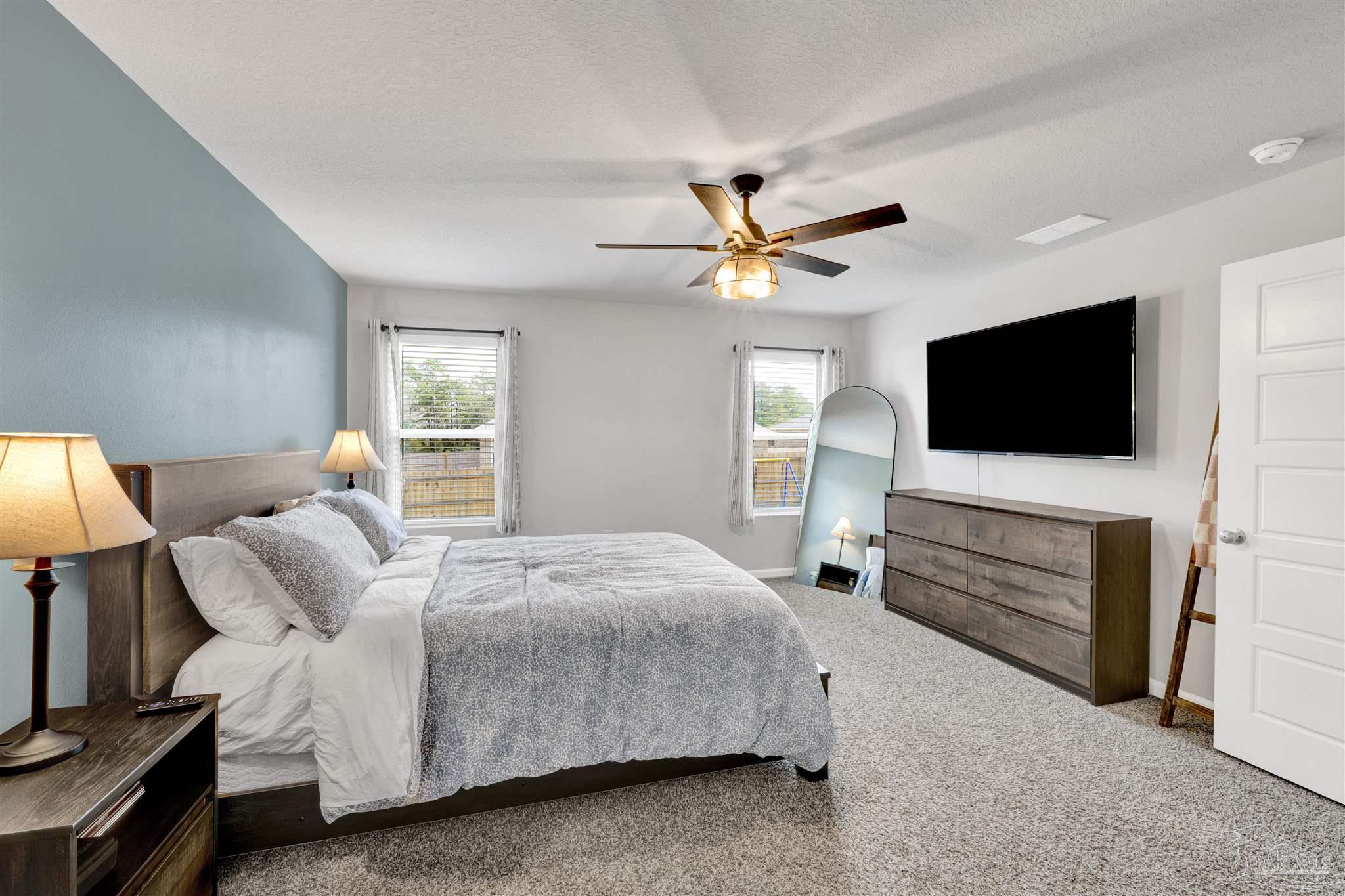 9747 MilleeLoop Loop Pensacola, FL 32526 - Photo 12 of 31 a bedroom with a bed and a flat screen tv