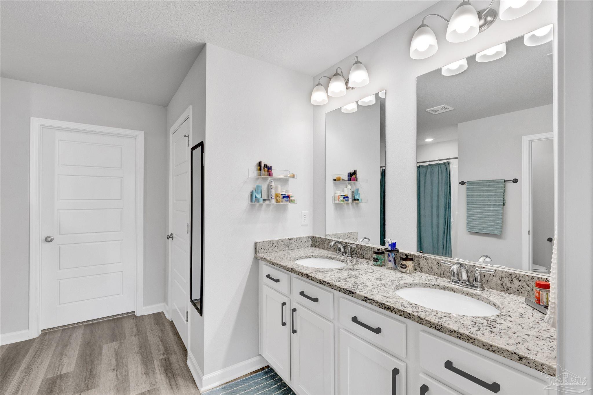 9747 MilleeLoop Loop Pensacola, FL 32526 - Photo 15 of 31 a bathroom with a granite countertop sink a large mirror and a shower