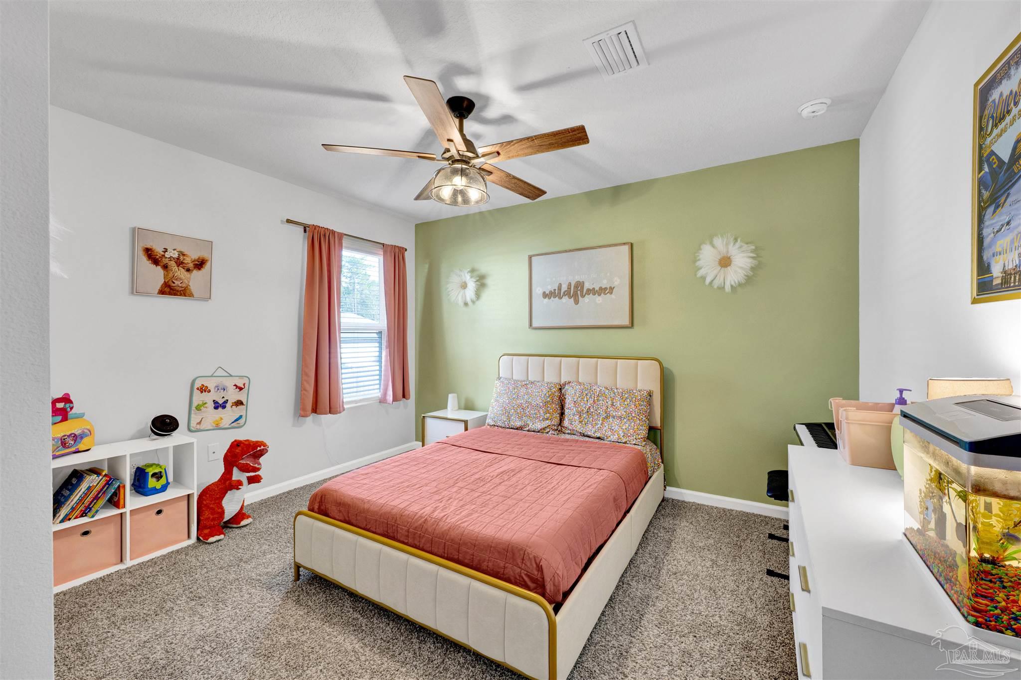 9747 MilleeLoop Loop Pensacola, FL 32526 - Photo 18 of 31 a bedroom with a bed and a chandelier